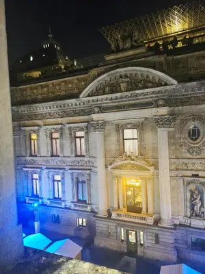 a large building at night with its lights on at Appartement Cozy Pauli 2 in Brussels