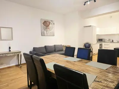 a living room with a table and a couch at Appartement Cozy Pauli 2 in Brussels