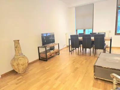 a living room with a table and chairs and a vase at Appartement Cozy Pauli 2 in Brussels