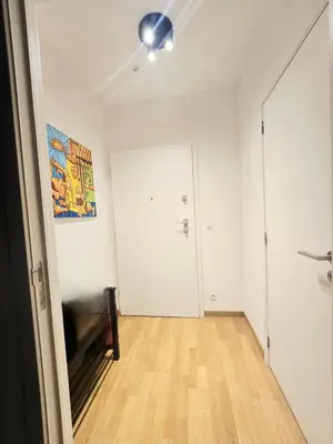 an empty room with a door and a hard wood floor at Appartement Cozy Pauli 2 in Brussels