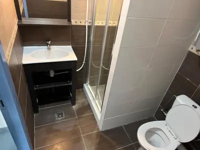 a small bathroom with a toilet and a sink at Mini Urban Stay in Brussels