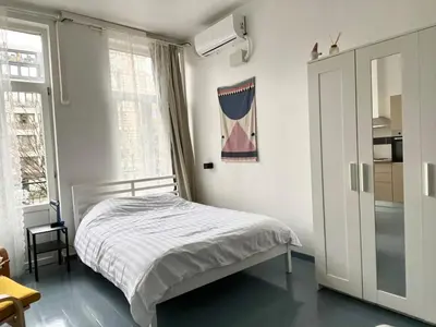 a small bedroom with a bed and a window at Mini Urban Stay in Brussels