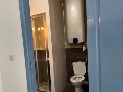 a bathroom with a toilet and a shower at Mini Urban Stay in Brussels