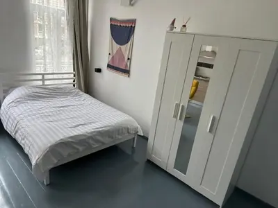 a small bedroom with a bed and a cabinet at Mini Urban Stay in Brussels