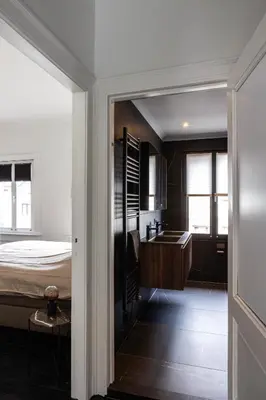 a bathroom with a bed and a sink in a room at Inner-Homes in Antwerp