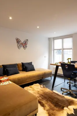 a living room with a couch and a butterfly on the wall at Inner-Homes in Antwerp