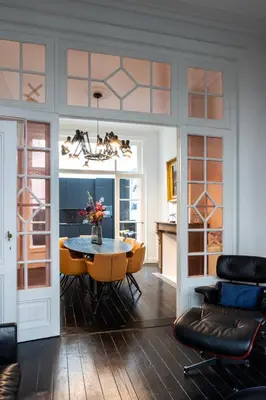 a living room with a table and chairs and a dining room at Inner-Homes in Antwerp