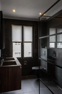 a black bathroom with a sink and a toilet at Inner-Homes in Antwerp