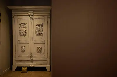 a cat is sitting in front of a white door at Casa Cava B&B in Dendermonde