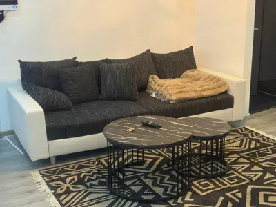 a living room with a couch and a table at Jps house in Brussels