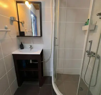 a bathroom with a sink and a shower at Tiny Central Stay in Brussels