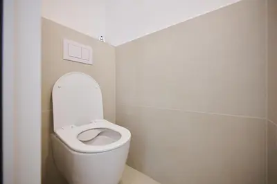 a bathroom with a toilet with the lid up at Toison d'Or & saunna 2 in Brussels