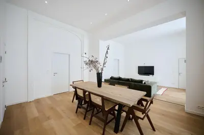 a living room with a table and a couch at Toison d'Or & saunna 2 in Brussels