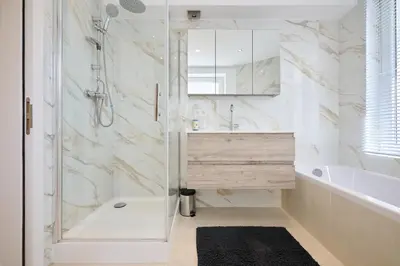 a bathroom with a shower and a tub and a sink at Toison d'Or & saunna 2 in Brussels