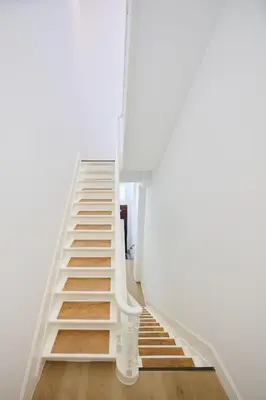 a ladder leading up to a white room at Toison d'Or House 4 in Brussels