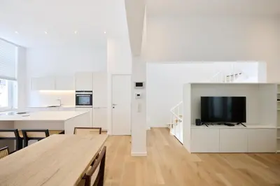 a kitchen and living room with a tv and a table at Toison d'Or House 4 in Brussels
