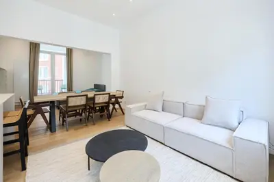 a living room with a white couch and a table at Toison d'Or House 4 in Brussels