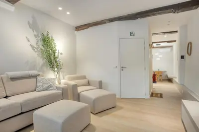 a living room with a couch and a chair and a table at Cozy Stay in the Heart of Mechelen in Mechelen