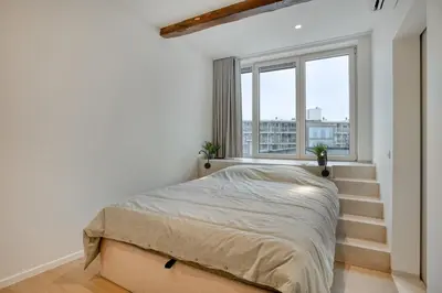 a bedroom with a bed and a window at Cozy Stay in the Heart of Mechelen in Mechelen