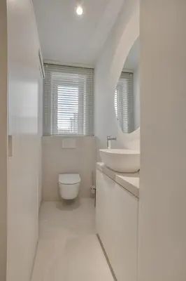 a white bathroom with a sink and a toilet at Cozy Stay in the Heart of Mechelen in Mechelen