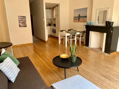 a living room with a couch and a table at Great apartment with a soul in the middle of the center in Ghent