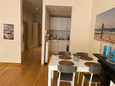 a kitchen with a table and chairs in a room at Great apartment with a soul in the middle of the center in Ghent