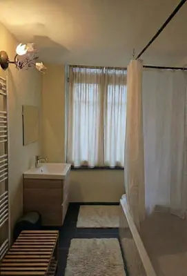 a bathroom with a tub and a sink and a shower at Pb155, balcony with street view in Brussels