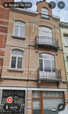 a brick building with windows and balconies on it at Pb155, balcony with street view in Brussels