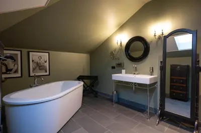 a bathroom with a large tub and a sink at Civiltà Boutique in Antwerp