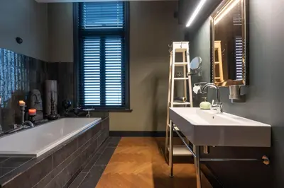 a bathroom with a large tub and a sink at Civiltà Boutique in Antwerp
