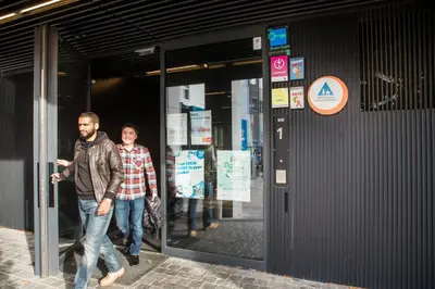 two men walking outside of a building at Antwerp Central Youth Hostel in Antwerp