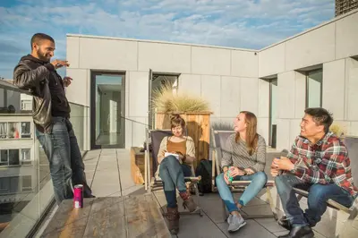 a group of people sitting on a patio at Antwerp Central Youth Hostel in Antwerp