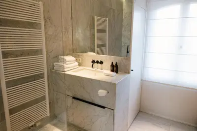 a bathroom with a sink and a mirror at A Place Antwerp - Boutique Suites & Flats - Schuttershofstraat 55 in Antwerp