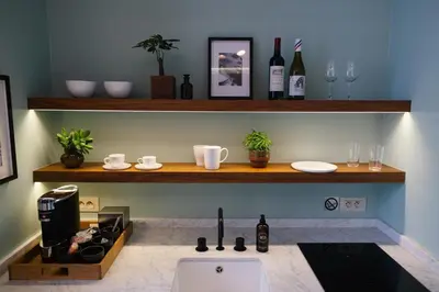 a kitchen with a sink and a counter with wine bottles at A Place Antwerp - Boutique Suites & Flats - Schuttershofstraat 55 in Antwerp
