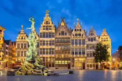 a large building with a statue in front of it at GuestHouse Groenplaats in Antwerp