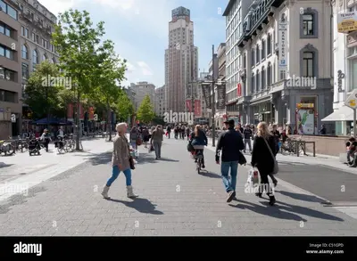 a group of people walking down a city street at GuestHouse Groenplaats in Antwerp