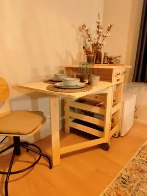 a wooden table with plates and bowls on it at Cozy Renovated Studio in Central Brussels in Brussels