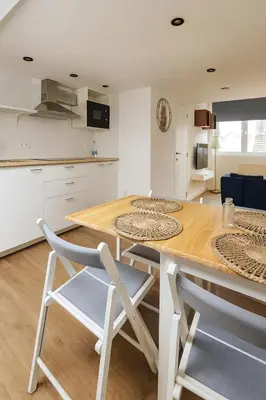 a kitchen with a wooden table and two chairs at Modern Loft 1BR Sofa Bed 10min to Center in Brussels