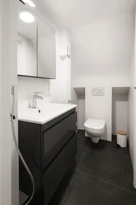 a bathroom with a sink and a toilet at Modern Loft 1BR Sofa Bed 10min to Center in Brussels
