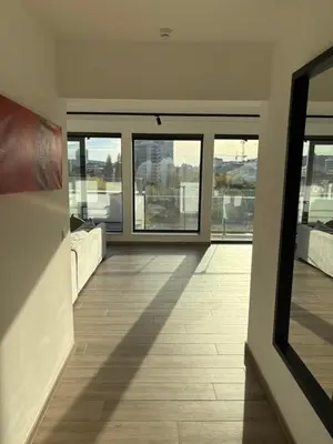 a room with a view of a building with windows at Penthouse avec vue imprenable sur Bruxelles in Brussels