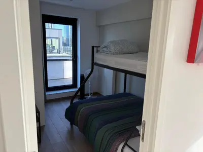 a small room with a bunk bed and a window at Penthouse avec vue imprenable sur Bruxelles in Brussels