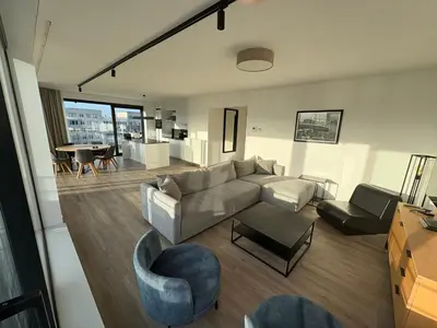 a living room with a couch and chairs and a table at Penthouse avec vue imprenable sur Bruxelles in Brussels