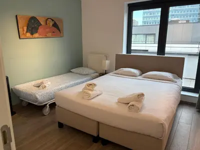 a bedroom with two beds with towels on them at Penthouse avec vue imprenable sur Bruxelles in Brussels