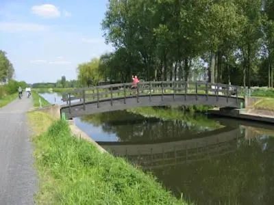 a bridge over a river with people walking on it at LoftAnno1940 in Lokeren