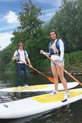 two people on a paddle board in the water at LoftAnno1940 in Lokeren