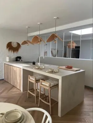 a kitchen with a counter with chairs and a table at LoftAnno1940 in Lokeren