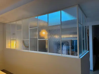 a large glass window on a wall in a room at LoftAnno1940 in Lokeren