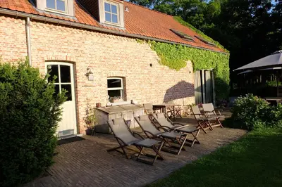 a table and chairs in front of a brick building at 15 inn in Mol