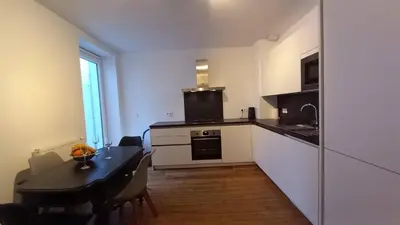 a kitchen with a table and a dining room at Charming apartment at heart of Brussels-Marolles in Brussels