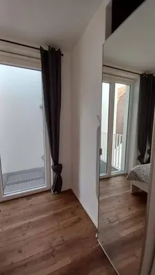 a mirror in front of a room with a window at Charming apartment at heart of Brussels-Marolles in Brussels